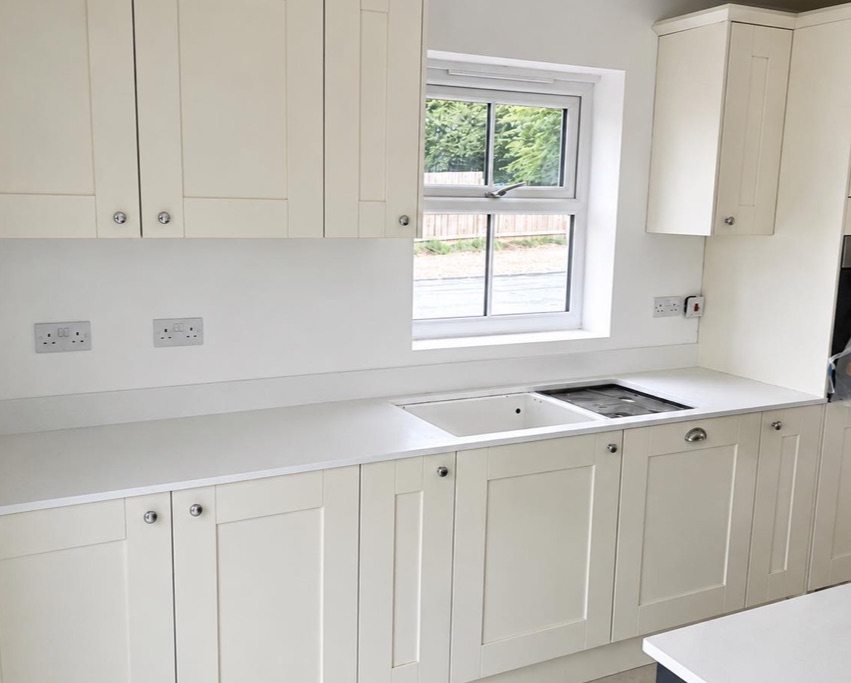 Fitted cabinetry and worktop around a kitchen window