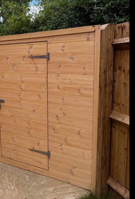 Timber garden gate and storage door built into fencing